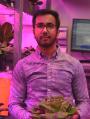 Man holding lettuce in pink glow room