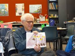 Friendly gentleman reading a kids book