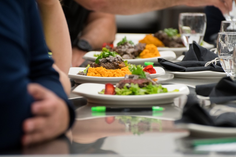 People at a table with plates of food