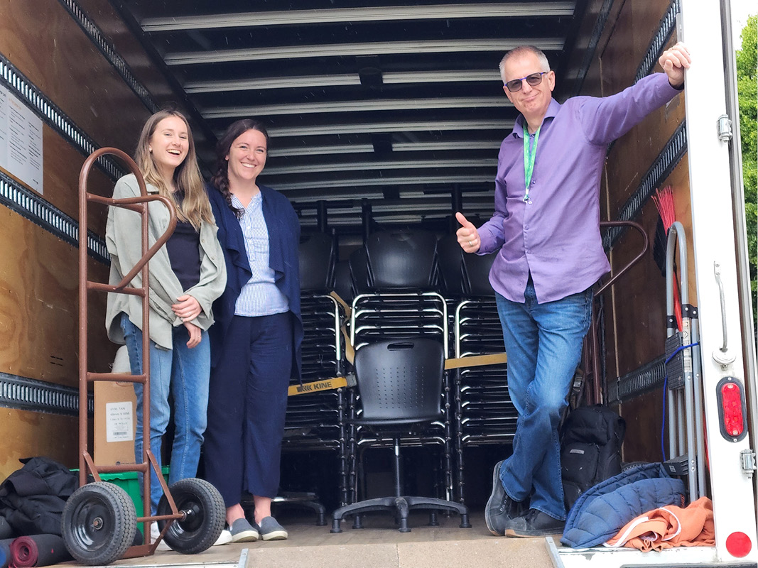 Sustainability office staff in a moving truck full of furniture