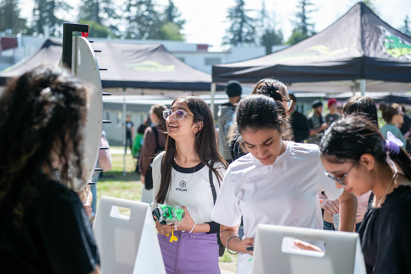 A student spins a prize wheel at Orientation