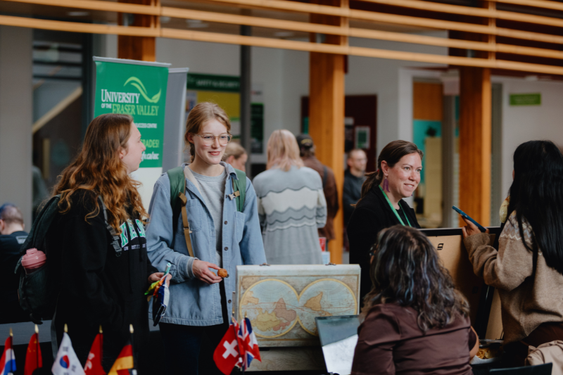 students engaging with a department table at Chilliwack Campus Expo