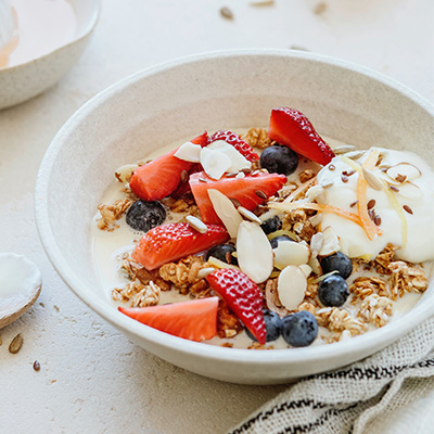 A bowl of oatmeal topped with fresh fruit and greek yougurt