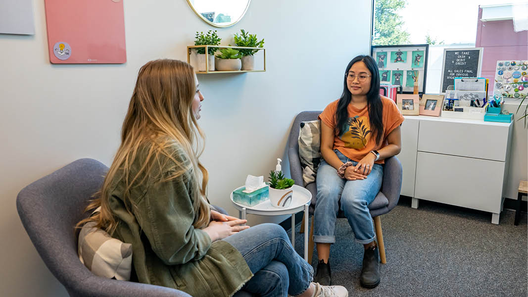 Two students chat in a private space at the Wellness Centre