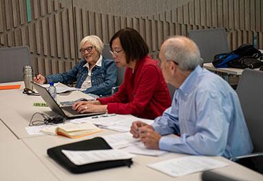 Three members of the UFVRA sitting at a table during a meeting.