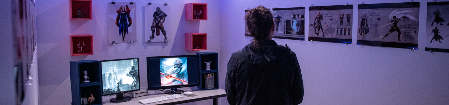 A person is looking at anime drawings on the wall in a room.