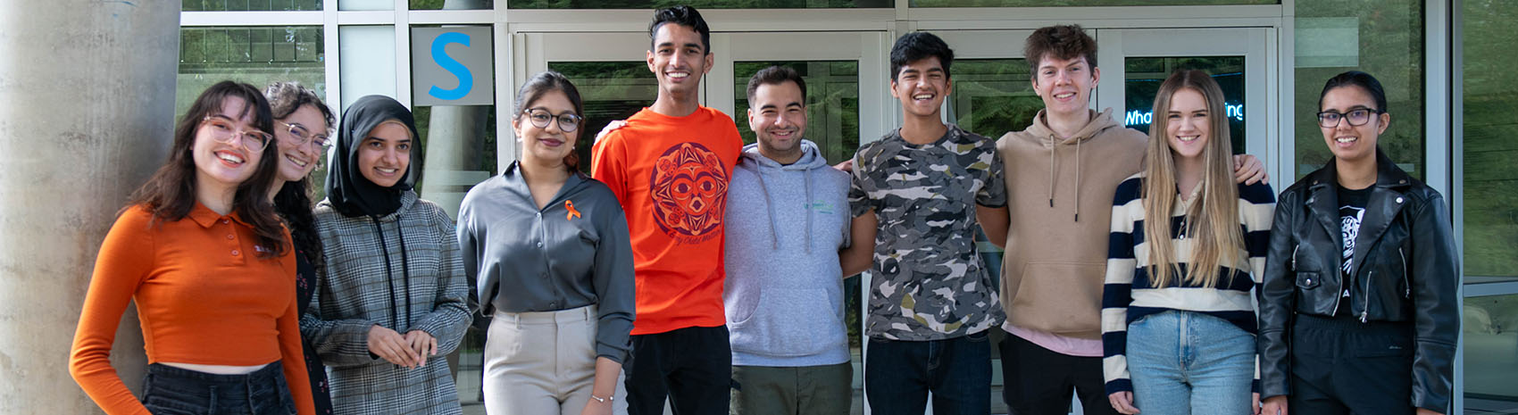 A group of people standing together smiling.